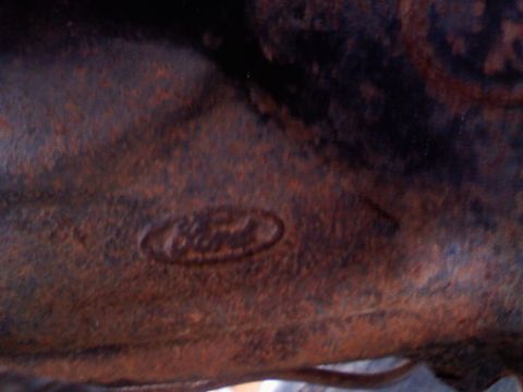1996 Ford Bronco - Embossed Ford oval logo visible on a heavily rusted metal component.