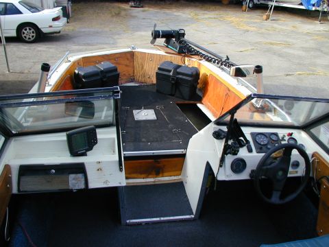 1968 Ford Mustang - The cockpit and deck area of a boat, equipped with a fish finder and storage compartments.