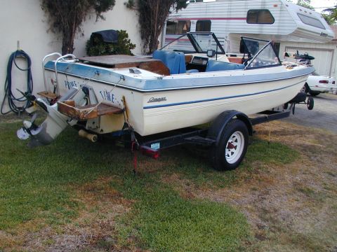 1968 Ford Mustang - A boat on a trailer is parked on a grassy area next to a house and garage, with a camper and another vehicle visible.