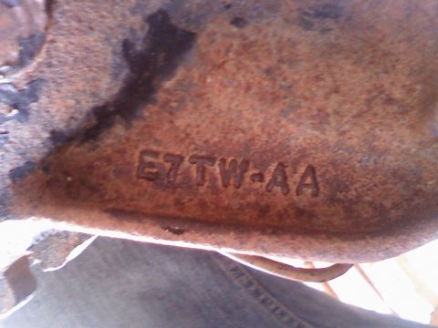 1996 Ford Bronco - Close-up of a cast iron part showing the stamped identification code E7TW-AA.