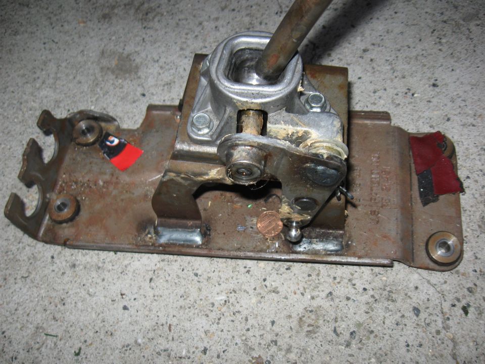 Manual transmission shifter assembly with linkage and shift lever on a metal plate