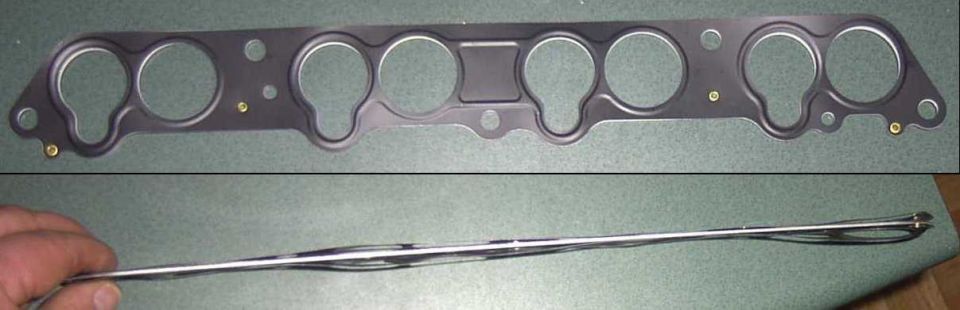 Intake manifold gasket shown from top and side. A hand holds the gasket from the side