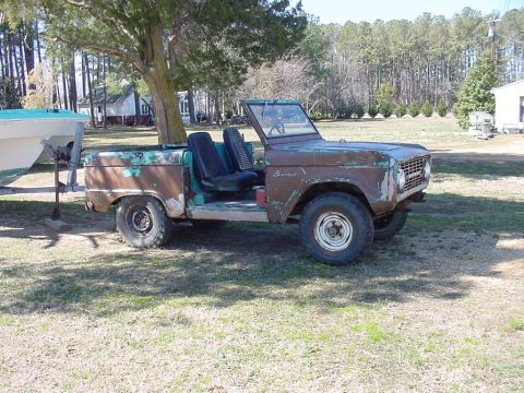 1978 Ford F-250 - This weathered Ford Bronco, likely from the late 1970s, sits in a yard with a boat on a trailer nearby.