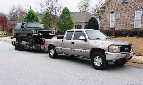 1979 Ford Bronco - A 1978 Ford Bronco is being transported on a trailer by a GMC Sierra pickup truck.