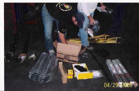 1979 Ford Bronco - Unpacking various automotive parts, including coil springs and other components, in a workshop setting.
