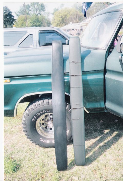 1979 Ford Bronco - Comparing two trim pieces next to a 1978 Ford Bronco. A second vehicle is visible in the background.