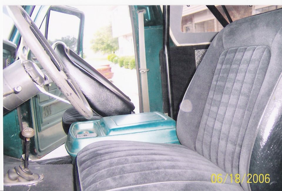 1979 Ford Bronco interior showing front seats, steering wheel, and floor shifter