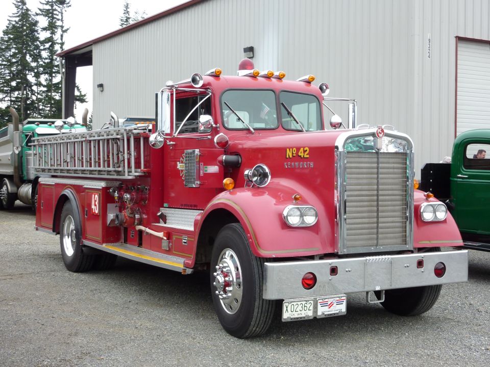 Red fire truck with chrome grille and ladder, license plate X 02362