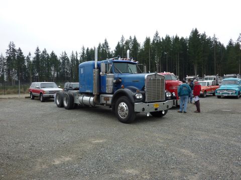1981 Kenworth W900A - Blue 1981 Kenworth W900A semi-truck is parked with other vehicles in a lot.