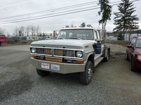 1981 Kenworth W900A - This 1970 Ford F-Series truck features a flatbed and custom front bumper. Another vehicle is visible to the right.