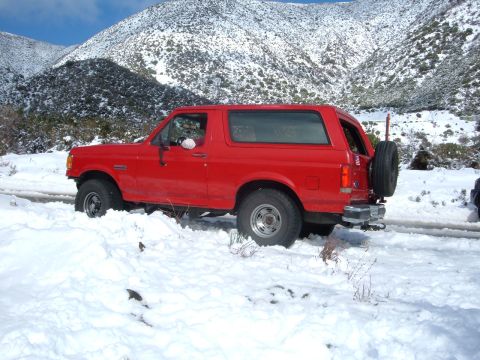 1988 Ford Bronco - 1988 Ford Bronco navigating a snowy mountain road.