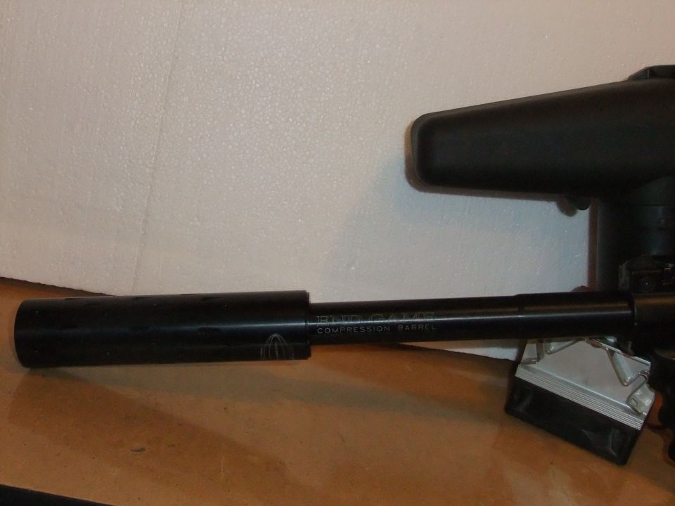 Paintball gun barrel with text 'COMPRESSION BARREL' visible