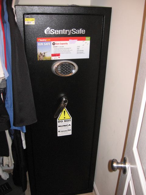 2001 Ford F-150 - A SentrySafe gun safe is shown in a closet next to clothing and a door.