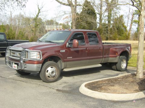 2007 Ford Mustang - This red and tan dually pickup truck is seen from the front quarter angle. The license plate is visible and reads 'CL465'.