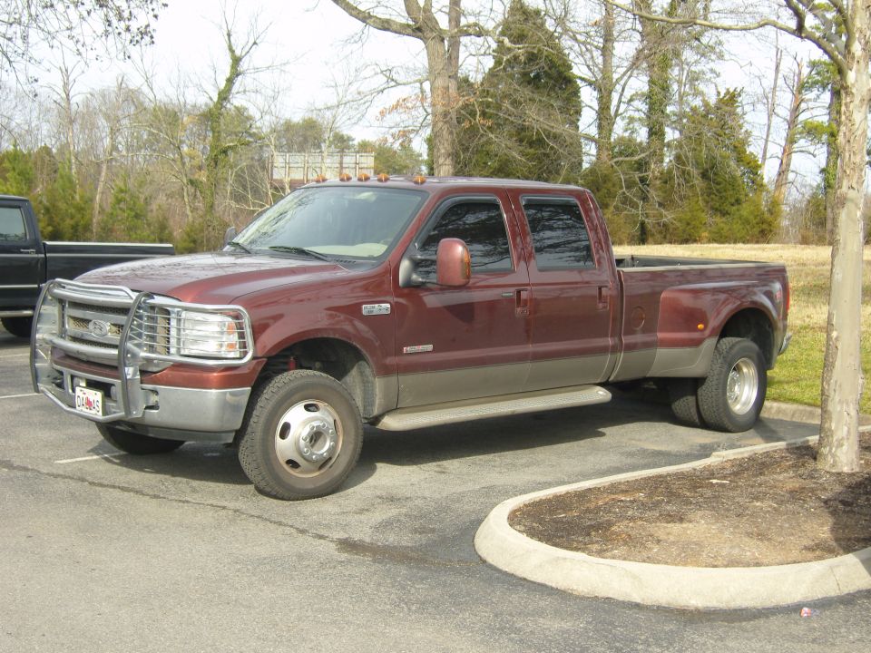 Red and tan dually pickup truck, front quarter view. License plate reads 'CL465'