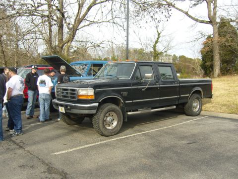 2007 Ford Mustang - Black crew cab pickup truck parked in a lot with other vehicles. The F-250 badge indicates it is likely from the early to mid-1990s.
