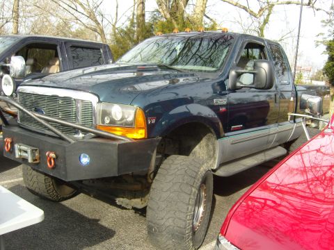 2007 Ford Mustang - Ford F-250 truck with custom front bumper and winch, parked outdoors.