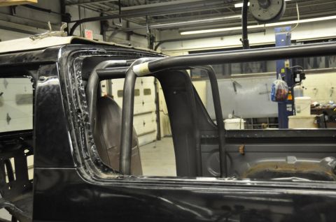 1996 Ford Bronco - Custom roll cage installation in progress inside a vehicle's interior.