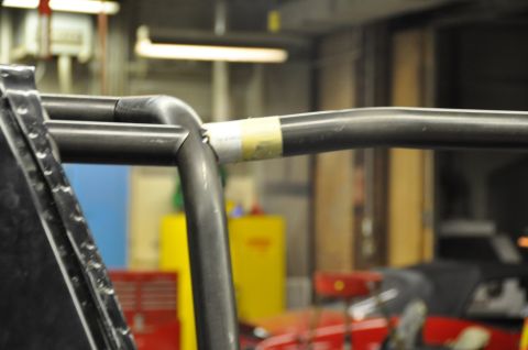 1996 Ford Bronco - This image shows a close-up of metal tubing, likely part of a vehicle's interior structure, with a section wrapped in tape.