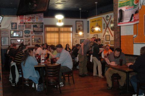 2007 Ford Mustang - Diners are seated at tables in a restaurant, with various posters and decorations adorning the walls.