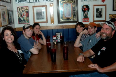 2007 Ford Mustang - Friends gather around a table in a casual dining establishment, enjoying each other's company.