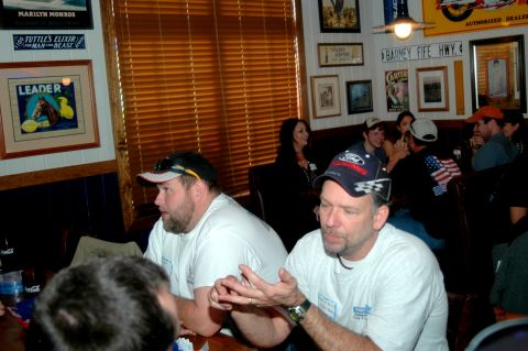 2007 Ford Mustang - People gather in a restaurant with various decorations on the walls.