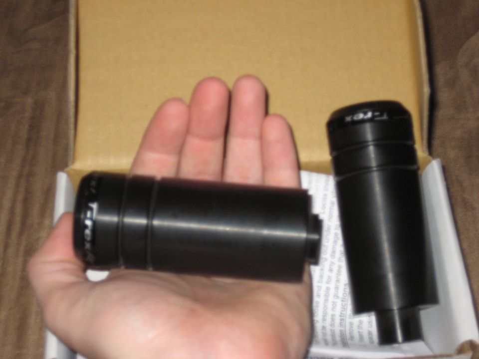 Black T-Rex frame sliders held in hand