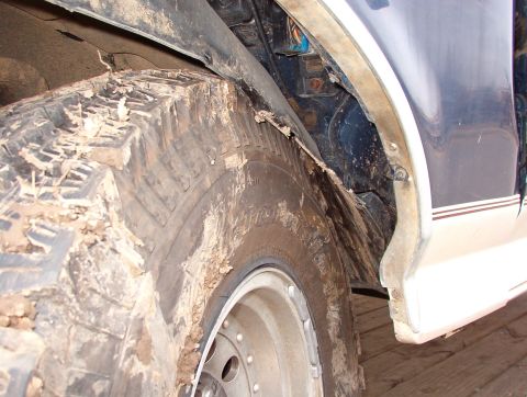 1993 Ford Bronco - The L radius arm is bent so far that the (flat) tire hits the firewall. But it's interesting to note that the frame's accordion didn't coll…