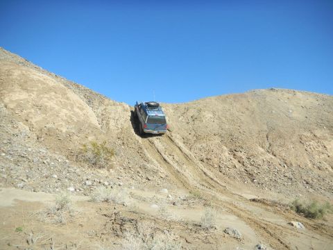 1997 Ford Ranger - SUV navigates a challenging off-road descent on a clear day.