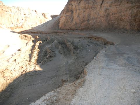1997 Ford Ranger - Tire tracks mark a path through a sandy canyon under a bright sky.
