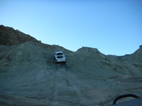 1997 Ford Ranger - Pickup truck navigates a challenging incline on a desolate, rocky landscape.