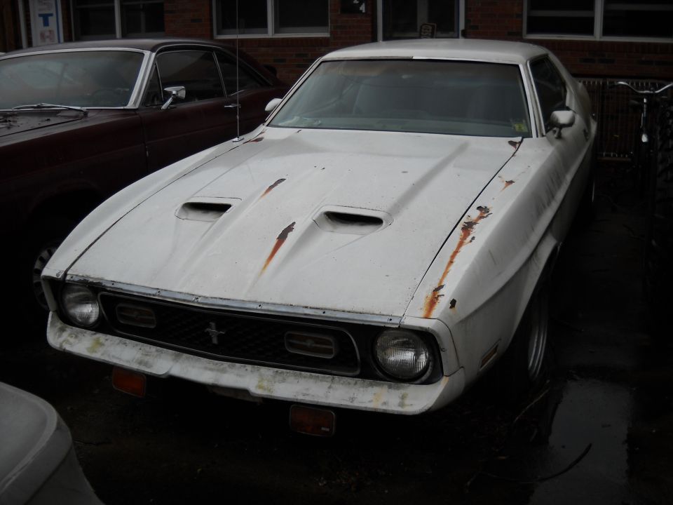White 1971 Ford Mustang with hood scoops and rust spots