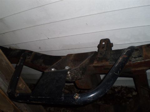 1978 Ford Bronco - Close-up view of a vehicle frame with an aftermarket skid plate attached.