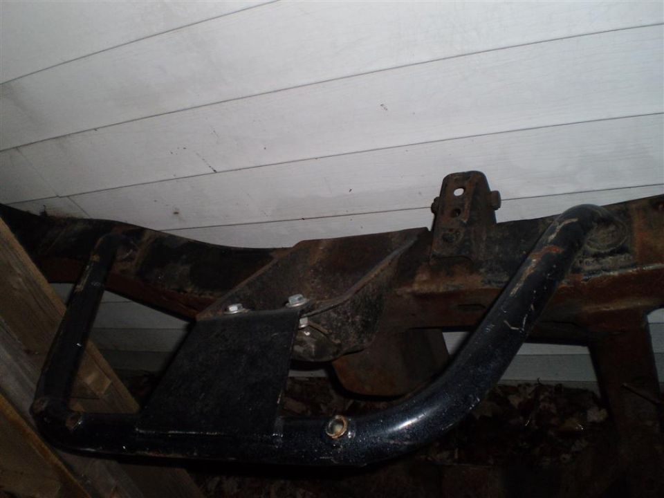 Frame with aftermarket skid plate, close-up view
