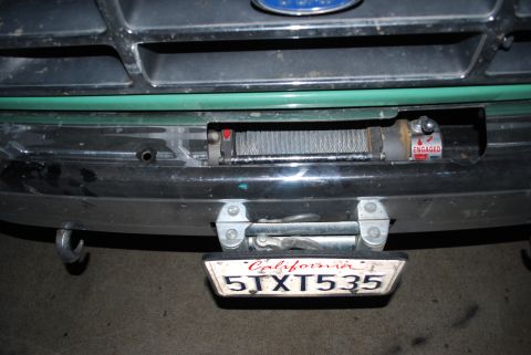 1996 Ford Bronco - The front of a 1996 Ford Bronco shows a winch mounted below the grille, with a California license plate attached.
