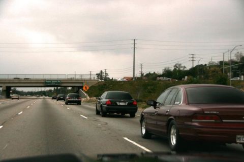 1992 Ford Crown Victoria - Maroon 1992 Ford Crown Victoria on highway with other vehicles.