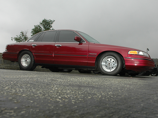 1992 Ford Crown Victoria, side view, red paint, custom wheels