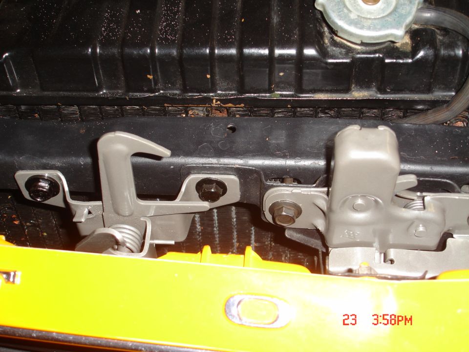 close-up of hood latches and radiator on a car
