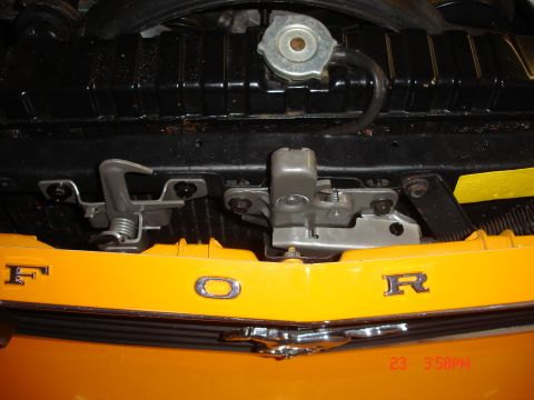 1978 Ford Mustang II - Close-up of a yellow Ford grille with chrome lettering and hood latch assembly.