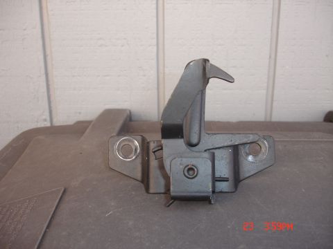 1978 Ford Mustang II - Close-up of a vehicle hood latch mechanism, likely for a car part replacement.
