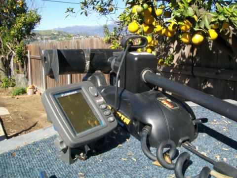 1968 Ford Mustang - A trolling motor and a Lowrance fish finder are shown mounted on a surface, with a backyard scene in the background.