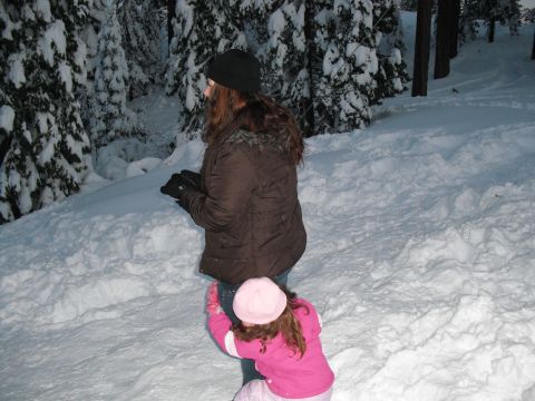 1991 Ford Bronco - A woman and child are in a snowy forest, surrounded by snow-covered trees.