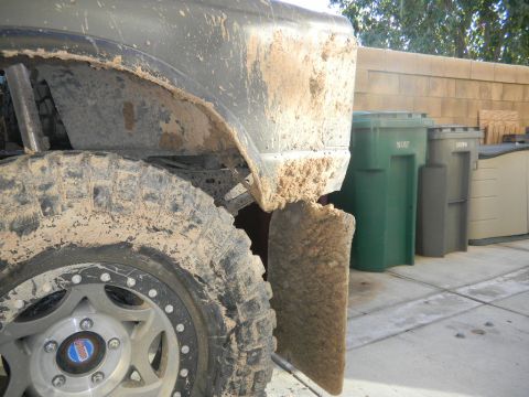 1997 Ford Ranger - This heavily mud-caked truck fender and tire suggest off-road use, with no clear year identification visible.