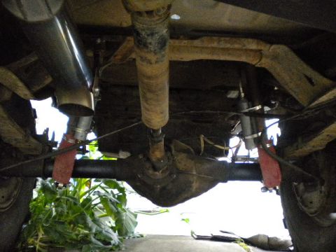 1989 Ford Bronco - This photo shows the undercarriage of a vehicle, focusing on the rear axle and suspension components.