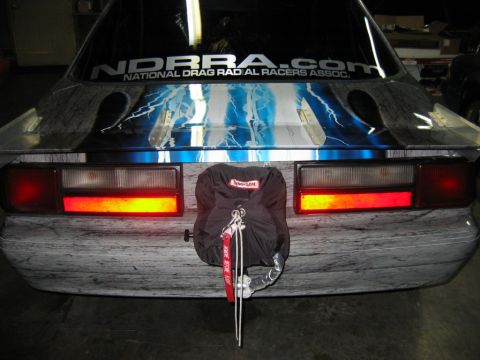 1992 Ford Mustang - Rear view of a 1992 Ford Mustang showing custom graphics and a drag racing parachute.