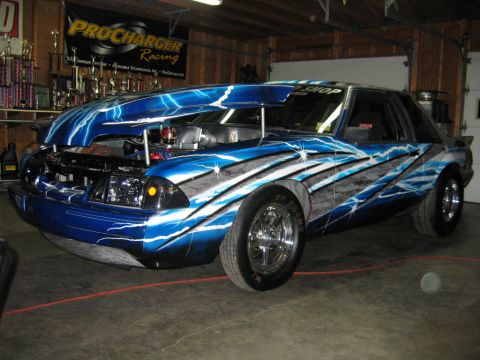 1992 Ford Mustang - This customized Ford Mustang features a striking lightning bolt paint scheme and a modified engine bay.
