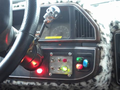 1989 Ford Bronco - Custom dashboard interior with a skull shifter and multiple illuminated toggle switches.