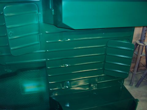 1948 Jeep Wrangler - Interior of a green vehicle with ribbed panels and floor, "SUPERMOTORS www.supermotors.net" text visible.