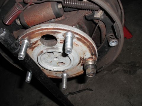 1991 Ford Bronco - Close-up of a vehicle's brake drum assembly, showing worn components and rust.