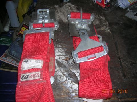 1985 Ford Bronco - Pair of red racing seatbelts with SFI Spec 16.1 certification and RJS Racing Equipment branding.